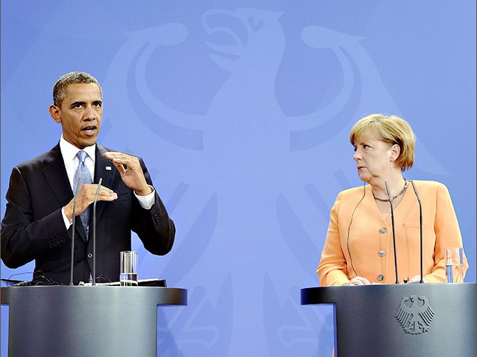 US President Barack Obama answers a question during a joint press conference with German Chancellor Angela Merkel following their bilateral meeting at the Chancellery in Berlin, Germany, on June 19, 2013. Obama arrived for his first visit as US president to Berlin on Tuesday for talks with German Chancellor Angela Merkel and a major open-air speech at the city's Brandenburg Gate. The 24-hour visit comes nearly 50 years to the day after John F. Kennedy's "Ich bin ein Berliner" solidarity pledge to the embattled western sectors of the city. AFP PHOTO/Jewel SAMAD