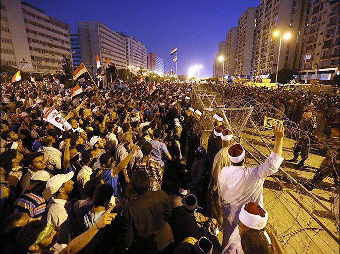 epa03777236 Supporters of the ousted Egyptian President Mohamed Morsi gather next to the headquarters of the Republican Guards, Cairo, Egypt, 05 July 2013. According to conflicting reports, shots were fired during a gathering of supporters of ousted Egyptian President Mohamed Morsi in Cairo, leaving at least three people killed. Backers of Morsi on 05 July staged huge protests across Egypt, where fighting between the Islamist leader's supporters and opponents have raised fears of deadly street violence in the Arab world’s most populous country. EPA/MOHAMMED SABER