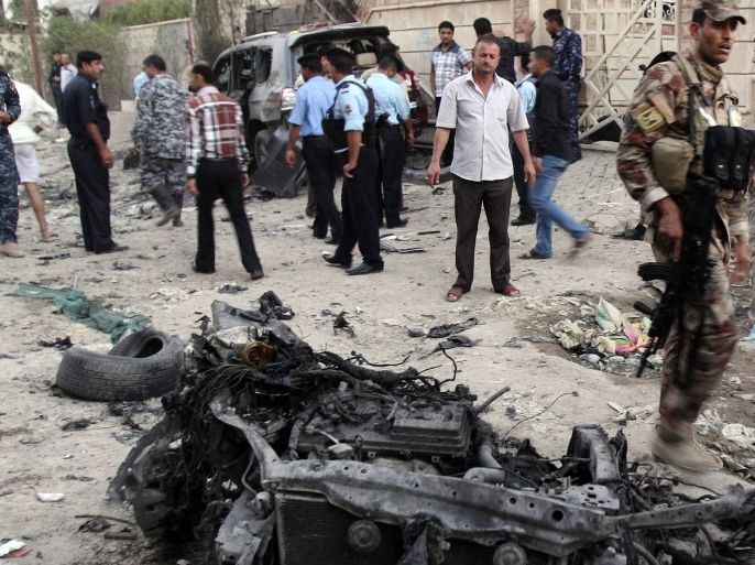 Security forces inspect the scene of a car bomb attack in Basra, 340 miles (550 kilometers) southeast of Baghdad, Iraq, Sunday, July 14, 2013. A wave of explosions tore through overwhelmingly Shiite cities south of Baghdad shortly before the Muslim faithful broke their Ramadan fasts, killing at least 22 and wounding dozens, according to officials, part of a sudden surge of violence that has brought Iraq to the brink of all-out sectarian conflict.