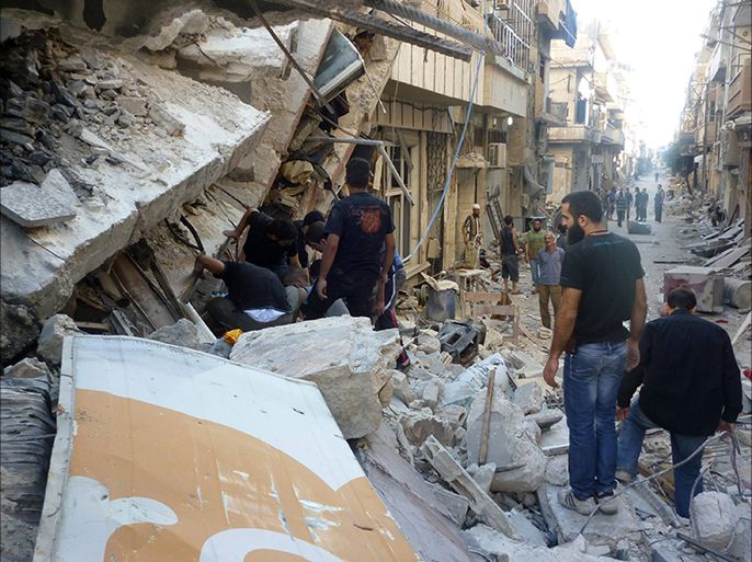 People search for survivors at a site hit by what activists say was a missile attack from the Syrian regime in the besieged area of Homs, July 25, 2013. Picture taken July 25, 2013. REUTERS/Yazan Homsy (SYRIA - Tags: POLITICS CIVIL UNREST)