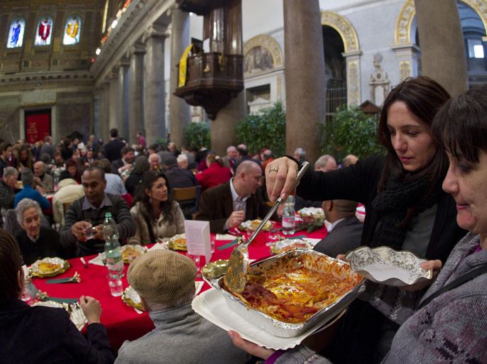 epa03517798 Poor people attend the traditional Christmas lunch at Santa Maria in Trastevere church, organized by the Community of Sant'Egidio in Rome, Italy, 25 December 2012. The Community of Sant'Egidio began in Rome in 1968, in the period following the Second Vatican Council. It is a movement of lay people and has more than 60,000 members, dedicated to evangelization and charity, in Rome, Italy and in more than 73 countries throughout the world. EPA/CLAUDIO PERI