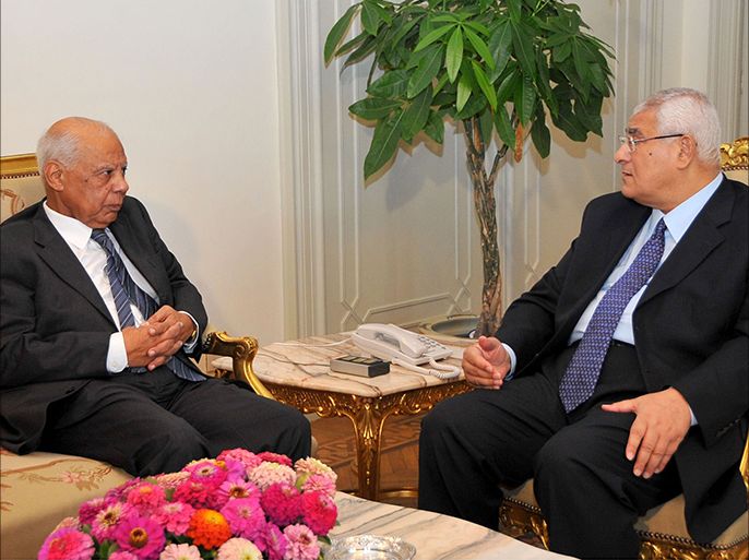 In this handout picture made available by the Egyptian presidency shows Egypt's interim president Adly Mansour (R) meeting with with new-appointed Prime Minister Hazem al-Beblawi, on July 9, 2013 in the Egyptian capital, Cairo . Mansour named liberal economist Beblawi, a former finance minister, as the country's new Prime Minister, while liberal opposition chief and Nobel Peace laureate Mohamed ElBaradei was named vice president for foreign relations. AFP PHOTO / EGYPTIAN PRESIDENCY