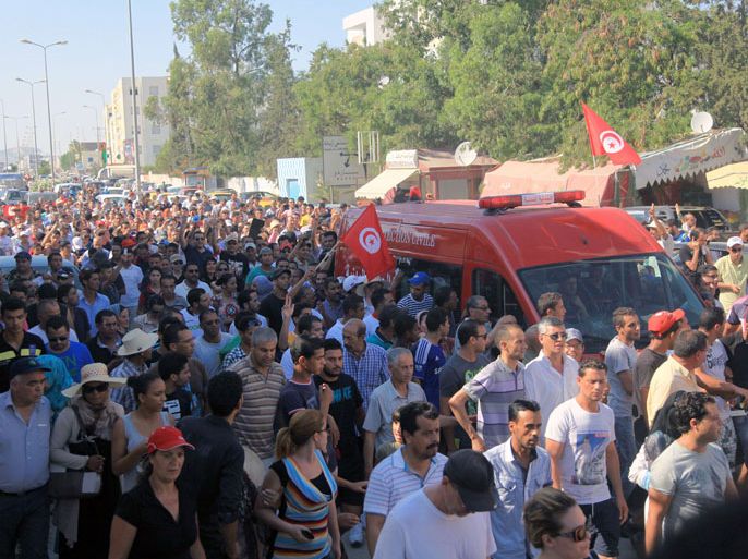 ambulance, carrying the body of Tunisian opposition politician Mohamed Brahmi, drives to the Charles Nicile Hospital in Tunis before an autopsy after Brahmi was gunned down in front of his home on July 25, 2013. The murder by unknown gunmen sparked angry street protests in central Tunis and the top opposition figure's birthplace of Sidi Bouzid for which he was an MP, AFP correspondents said, as well as a call for a general strike on Friday. AFP PHOTO / FETHI BELAID