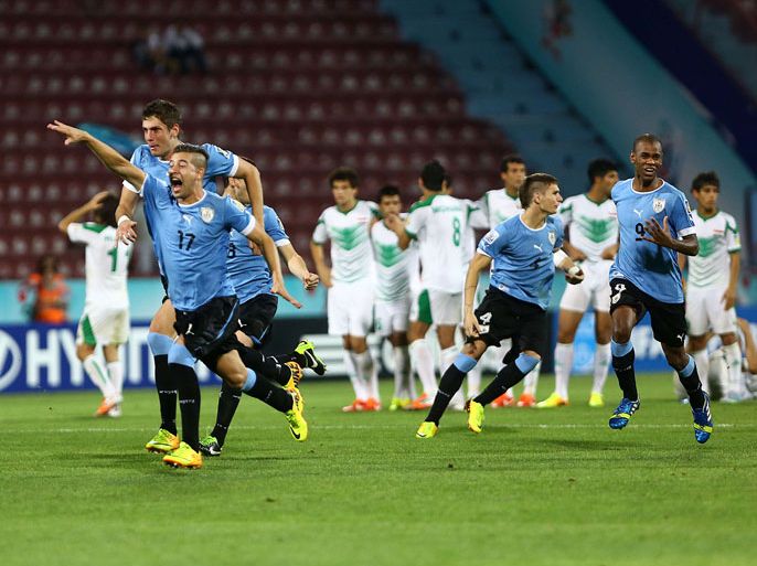 Uruguay's players celebrate their victory over Iraq in the penalty shout out of a FIFA Under 20 World Cup semi final football match at the Huseyin Avni Aker stadium in Trabzon on July 10, 2013. AFP PHOTO/BEHROUZ MEHRI