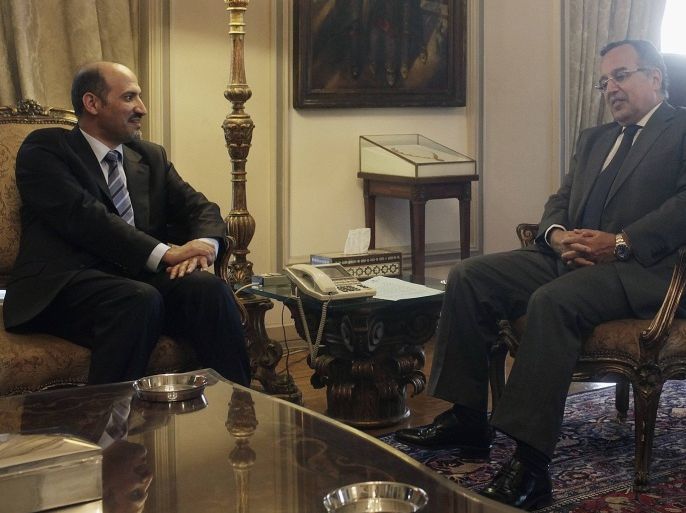 Ahmad Jarba (L), head of the opposition Syrian National Coalition, meets with Egyptian Foreign Minister Nabil Fahmy at the foreign ministry headquarters in Cairo July 21, 2013.