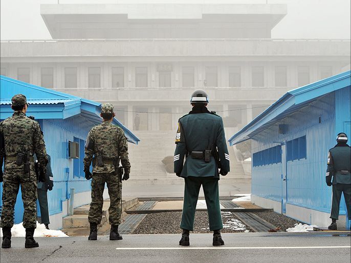 (FILES) A file photo taken on February 27, 2013 shows South Korean soldiers standing guard at the truce village of Panmunjom in the demilitarized zone dividing North and South Korea. North and South Korea agreed to hold talks at the truce village of Panmunjom on July 6 about reopening a jointly-run industrial estate which had shut down amid high military tensions. The announcement came a day after the North restored a cross-border hotline and said it would let the South's businessmen visit the Kaesong estate just north of the border to check on their closed factories. AFP PHOTO / FILES / JUNG YEON-JE