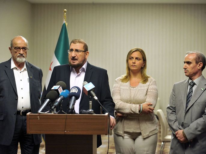 Members of Syrian National Coalition (SNC) Haitham Maleh (L) , Abdul al Karim Bakkar (2ndL) Farah al Atassi (2ndR) and Abdul Rahman Battra (R) give a press conference, on July 4, 2013 in Istanbul, to announce taht Syria's main political opposition will attempt to nominate a new leader to unify a fractured coalition. AFP PHOTO/ OZAN KOSE