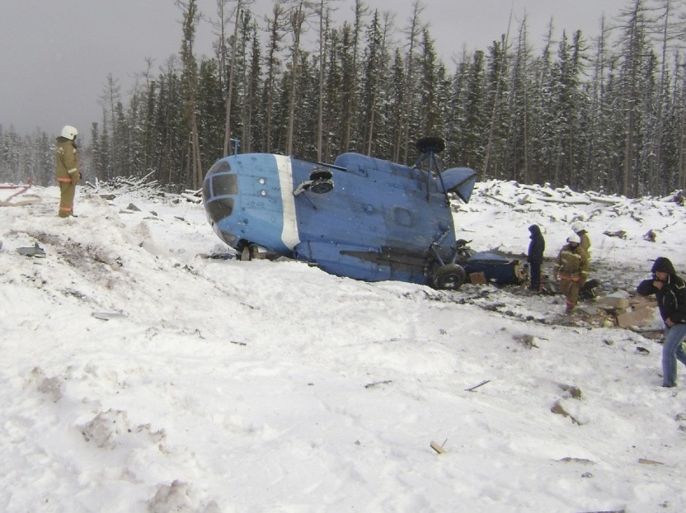 Russian Emergencies Ministry members work at the site of the crashed MI-8 helicopter in Krasnoyarsk territory October 17, 2012. The helicopter with 8 passengers and 4 crew members onboard fell down on Wednesday in Evenkiysky District of the Krasnoyarsk territory, which killed one person and seriously injured other three, according to local media.