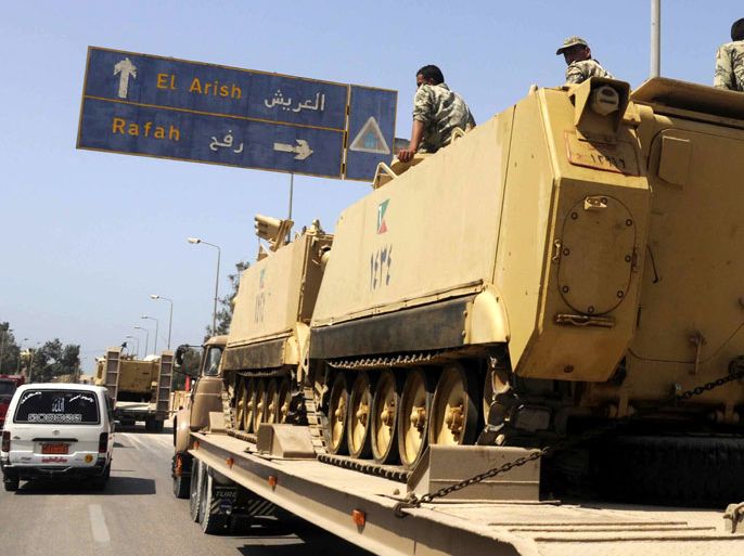 epa03709059 Army truck carrying tanks heads to the Sinai Peninsula in preparation for a possible attempt to rescue kidnapped policemen and soldiers, in al-Arish, Egypt, 20 May 2013. Seven policemen and soldiers were kidnapped in the city of al-Arish on 16 May. Tanks and armored personnel carriers were seen crossing the Suez Canal into Sinai. The abductors are reportedly asking for relatives to be released from prison. EPA/STR