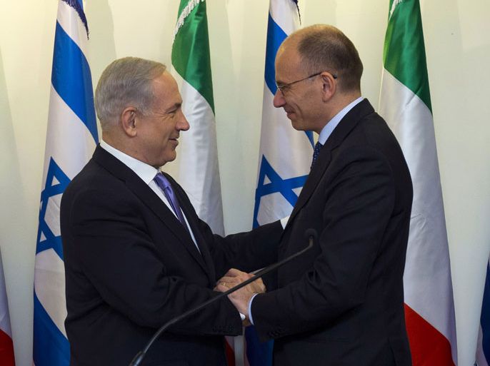 Israeli Prime Minister Benjamin Netanyahu (L) greets his Italian counterpart Enrico Letta before their meeting in Jerusalem on July 1, 2013. AFP PHOTO/POOL/RONEN ZVULUN