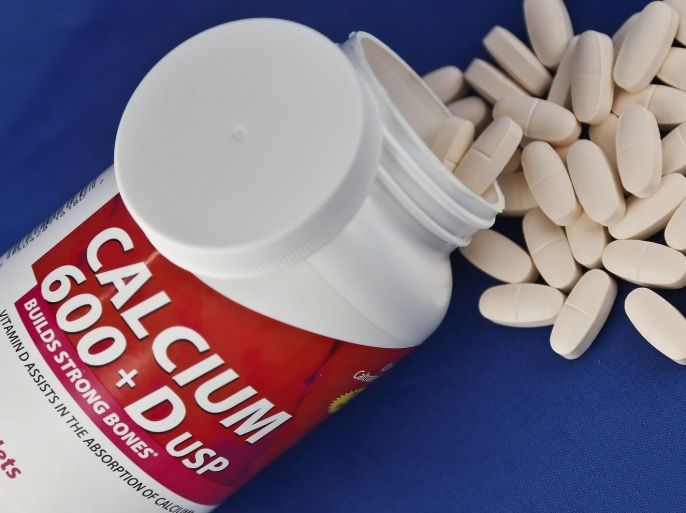 A photo illustration shows a container of over the counter calcium supplements, Monday, Feb. 25, 2013. A government advisory group says the relatively low doses found in today's dietary supplements don't prevent broken bones in women after menopause.