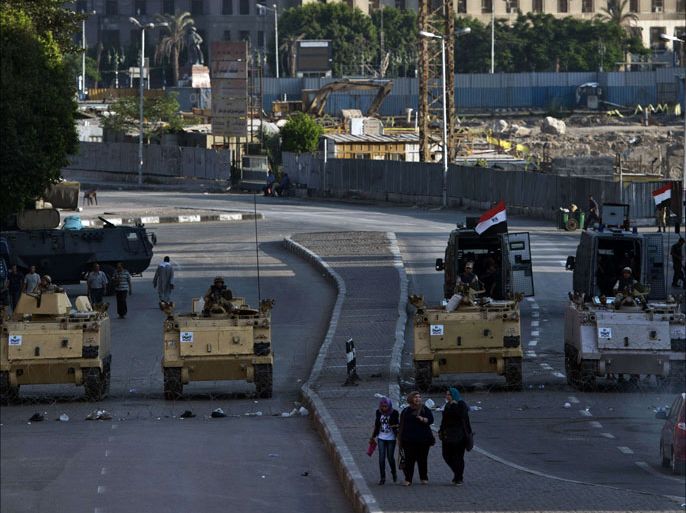 Egyptian army armoured personnel carriers (APC) are seen stationed in front of the Egyptian Museum in Tahrir Square on August 18, 2013 in Cairo. Supporters of ousted Egyptian president Mohamed Morsi announced new demonstrations as the country grew increasingly polarised and the death toll in four days of violence topped 750. AFP PHOTO/KHALED DESOUKI
