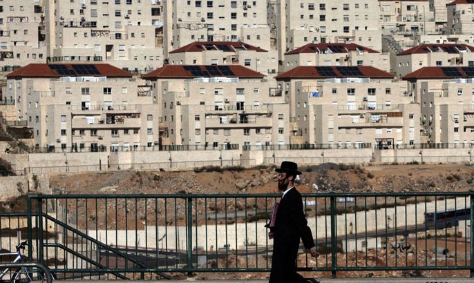 (FILES) -- An Ultra-Orthodox Jewish man walks in the West Bank settlement of Beitar Elit, an ultra-Orthodox bastion south of the biblical Palestinian town of Bethlehem, on December 1, 2009. Israel is inviting bids to build over 1,000 settler homes in the West Bank, including east Jerusalem, the housing ministry said on August 11, 2013, ahead of peace talks with the Palestinians. AFP PHOTO/ MENAHEM KAHANA