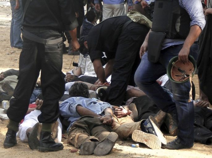 Members of the Muslim Brotherhood and supporters of deposed Egyptian president Mohamed Mursi, lie face down on the ground with their hands secured behind them, after being detained by riot police at Rabaa Adawiya square, where they had been camping, in Cairo August 14, 2013. The death toll from a raid on Mursi supporters, in Cairo and other clashes nationwide has climbed to 149, the Health Ministry said on Wednesday.