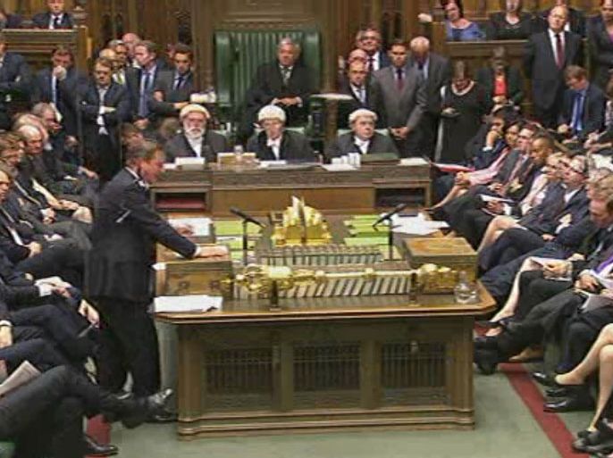 UNITED KINGDOM : A video grab from footage broadcast by the UK Parliament’s Parliamentary Recording Unit (PRU) via Parliament TV on August 29, 2013 shows British Prime Minister David Cameron (L) speaking at the dispatch box during the debate about a response to the situation in Syria in the Houses of Parliament in central London on August 29, 2013. Lawmakers recalled to parliament vote on august 29 on Britain's response to chemical weapons attacks in Syria -- but approval for military action will require a second vote after the opposition blocked Prime Minister David Cameron's way. RESTRICTED TO EDITORIAL USE - MANDATORY CREDIT