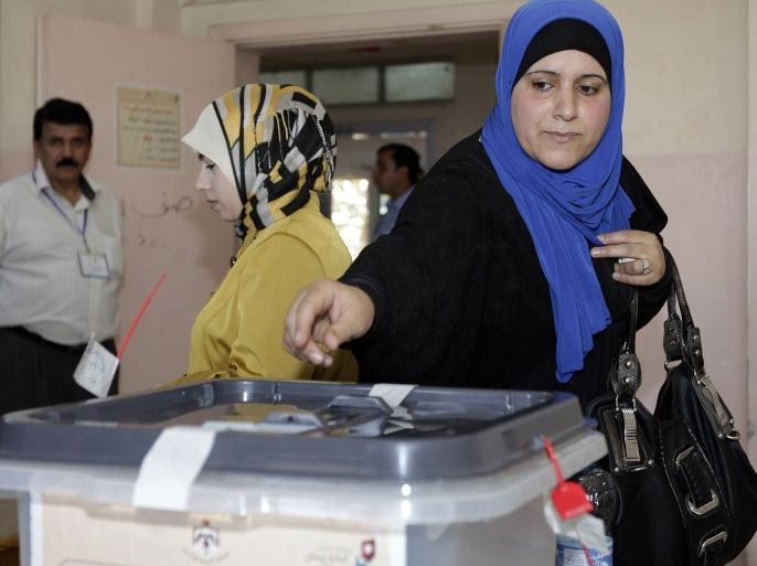A Jordanian woman casts her ballot for municipal elections at a polling station in Amman on August 27, 2013. The Muslim Brotherhood, the main opposition party, is boycotting the polls, charging that, despite repeated promises since the Arab Spring of 2011, there is no real readiness for change.