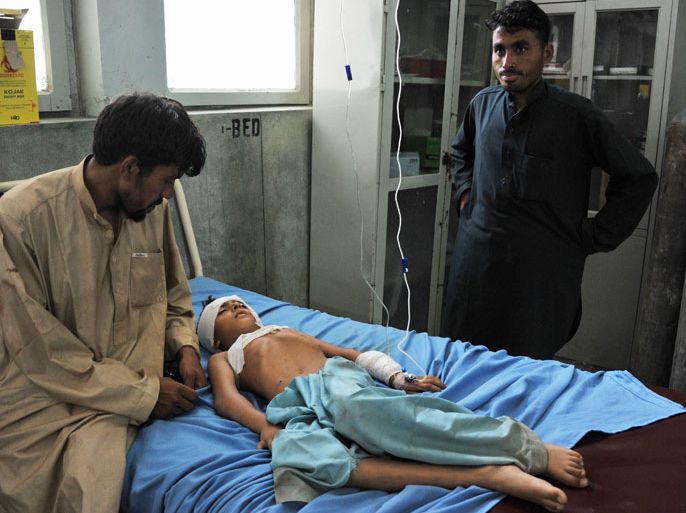 SM756 - Jalalabad, Nangarhar, AFGHANISTAN : A wounded Afghan boy receives treatment at a hospital in Jalalabad after an explosion in the Ghani Khel district of Nangarhar province on August 8, 2013. An explosion killed at least 10 women in a graveyard in eastern Afghanistan on August 8, officials said, as the country celebrated the Eid al-Fitr holiday marking the end of Ramadan. AFP PHOTO/ Noorullah Shirzada