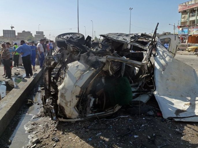Iraqis inspect the site of a car bomb explosion in the impoverished district of Sadr City in Baghdad on July 29, 2013, after 11 car bombs hit nine different areas of Baghdad, seven of them Shiite-majority, while another exploded in Mahmudiyah to the south of the capital. More than 3,000 people have been killed in violence since the beginning of the year, according to AFP figures based on security and medical sources -- a surge in unrest that the Iraqi government has so far failed to stem.