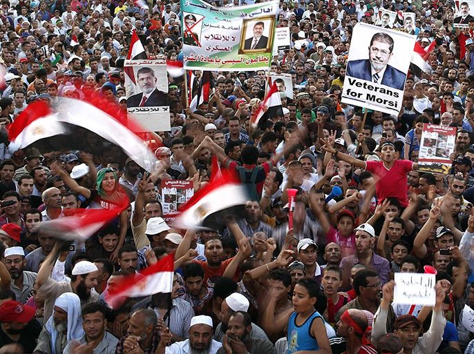 Members of the Muslim Brotherhood and supporters of deposed Egyptian President Mohamed Mursi chant slogans at Rabaa Adawiya Square, where they are camping in the Nasr city area, east of Cairo August 11, 2013. Leaders of Mursi's Muslim Brotherhood mounted a stage at the site on Sunday to demand that he brought back to power. Egyptian police are expected to start taking action early on Monday against supporters of Mursi who are gathered in protest camps in Cairo, security and government sources said on Sunday, a move which could trigger more bloodshed.