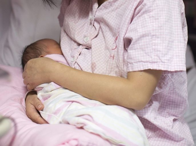 A mother breastfeeds her newborn baby in the post-natal ward of the Kwong Wah Hospital in Hong Kong, China, 05 August, 2013. The Hong Kong's Department of Health, the Hospital Authority and the UNICEF Baby Friendly Hospital Initiative Hong Kong Association (BFHIHKA) are promoting breastfeeding in the territory. The results of the 2013 World Breastfeeding Week Annual Survey of UNICEF BFHIHKA showed that over 85% of mothers initiated breastfeeding after being discharged from hospitals, the highest ever in 20 years. World Breastfeeding Week is celebrated every year from 01 to 07 August to encourage breastfeeding and improve the health of babies around the world.