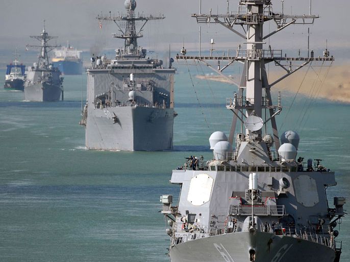 (FILES) A handout picture released on September 23, 2008 by the US Navy shows the guided-missile destroyer USS Ramage (DDG 61), the amphibious transport dock ship USS Carter Hall (LSD 50) and the guided-missile destroyer USS Roosevelt (DDG 80) transiting through the Suez Canal. US Defense Secretary Chuck Hagel on August 24, 2013 strongly suggested the Pentagon was moving forces into place ahead of possible military action against Syria, even as President Barack Obama voiced caution. Three other destroyers are currently deployed in the area -- the USS Gravely, the USS Barry and the USS Ramage and the USS Mahan will be kept in the region. AFP PHOTO/US NAVY/CHAD R. ERDMANN == RESTRICTED TO EDITORIAL USE ==