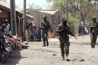 (FILES) This picture taken on April 30, 2013 shows Nigerian troops patrolling in the streets of the remote northeast town of Baga, Borno State. Nigeria's military said on May 16, 2013 that it was ready to launch air strikes against Boko Haram Islamists as several thousand troops moved to the remote northeast to retake territory seized by the insurgents. A force of "several thousand" soldiers along with fighter jets and helicopter gunships have been deployed for the offensive in Borno, Yobe and Adamawa state, he added. AFP PHOTO/PIUS UTOMI EKPEI