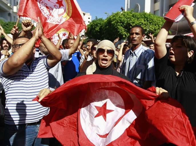 Anti-government protesters wave Tunisian flags as they rally for the dissolution of the Islamist-led government in Sfax, 170 miles (270 km) southeast of Tunis September 26, 2013. Thousands protested in cities across Tunisia on Thursday to call on the ruling Islamist Ennahda party to step down immediately to make way for new elections to end a stalemate with its secular opponents.