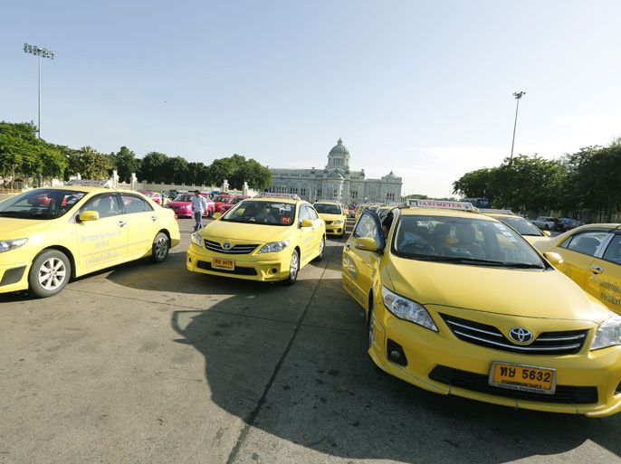 A Thai taxi drivers park their cars on the Royal Plaza during a protest after a hike in the price of liquefied petroleum gas (LPG) in Bangkok, Thailand, 26 August 2013. Hundreds of Taxi drivers demanded remedial measures be taken by the government to counter rising LPG. EPA/NARONG SANGNAK