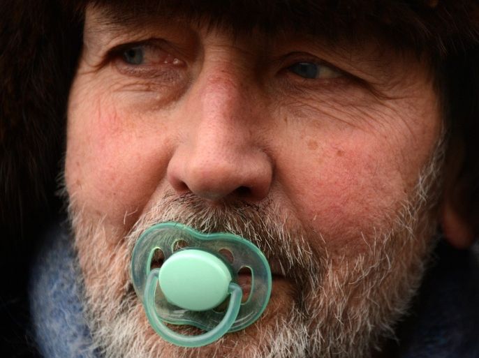 One of at least 20,000 Russian opposition supporters rallies with a pacifier in his mouth on January 13, 2013 on the Boulevard Ring in the center of Moscow against a Kremlin law that banned US adoptions of Russian orphans. The protest dubbed 'the March Against Scoundrels' was aimed at naming and shaming the lawmakers who fast-tracked the anti-adoption bill through the lower house parliament, the State Duma.