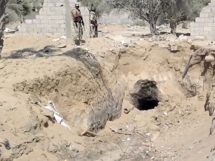 In this image taken from video, Egyptian Army personnel supervise the destruction of tunnels between Egypt and the Gaza Strip at the border, near the town of Rafah, northern Sinai, Egypt, Tuesday Sept. 3, 2013. Tunnels between Egypt and the Gaza have been used to smuggle everything from weapons, to cigarettes and fuel but now the Egyptian military appears determined to close the tunnels once and for all.