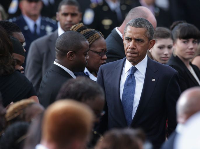 U.S. President Barack Obama attends a memorial service for victims of the Washington Navy Yard shooting at the Marine Barracks September 22, 2013 in Washington, DC. The president and the first lady visited with families of the victims in the deadly shooting at the Washington Navy Yard. Thirteen people, including the gunman Aaron Alexis, were killed in the incident