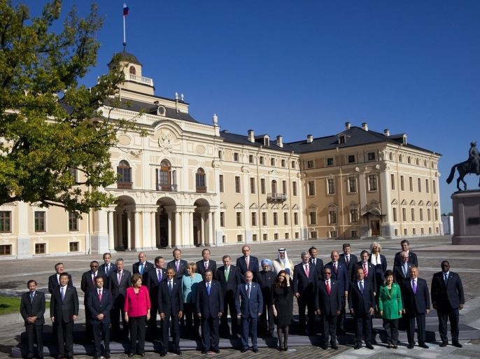 Russia's President Vladimir Putin, center foreground, stands with G-20 leaders during a group photo outside of the Konstantin Palace in St. Petersburg, Russia on Friday, Sept. 6, 2013. World leaders are discussing Syria's civil war at the summit but look no closer to agreeing on international military intervention to stop it.