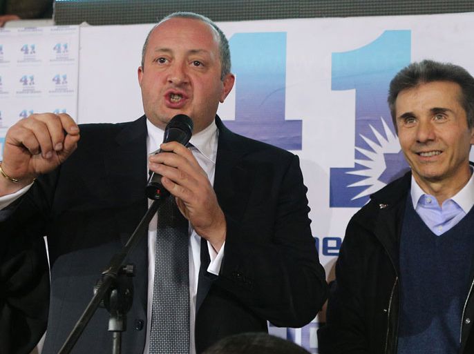 Presidential candidate Giorgi Margvelashvili (L) speaks as Georgian Prime Minister Bidzina Ivanishvili looks on as they celebrate at the Georgian Dream coalition's headquarters in Tbilisi, on October 27, 2013. A close ally of billionaire Georgian Prime Minister Bidzina Ivanishvili was on course to win a crushing victory at presidential polls on October 27, 2013 in the post-Soviet country, partial results from the electoral commission showed. Giorgi Margvelashvili -- from Ivanishvili's Georgian Dream coalition -- was on 63.8 percent of the vote with some 12 percent of polling stations counted, the electoral commission said, with challenger David Bakradze from outgoing president Mikheil Saakashvili's United National Movement party, back on 21.3 percent. AFP PHOTO