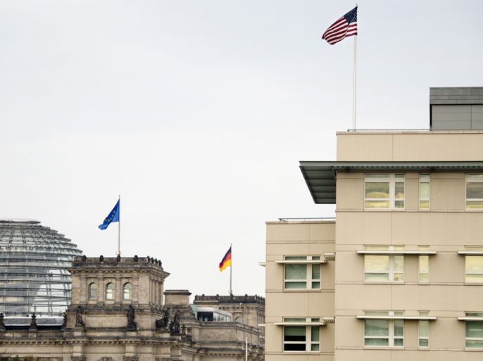 Berlin, Berlin, GERMANY : The stars and stripes fly on top of the US embassy (R) next to the German parliament (L) in Berlin on October 25, 2013. The alleged US spying on German Chancellor Angela Merkel's mobile phone may have been run out of its Berlin embassy, less than a kilometre (mile) from the chancellery, media reported. AFP PHOTO / ODD ANDERSEN
