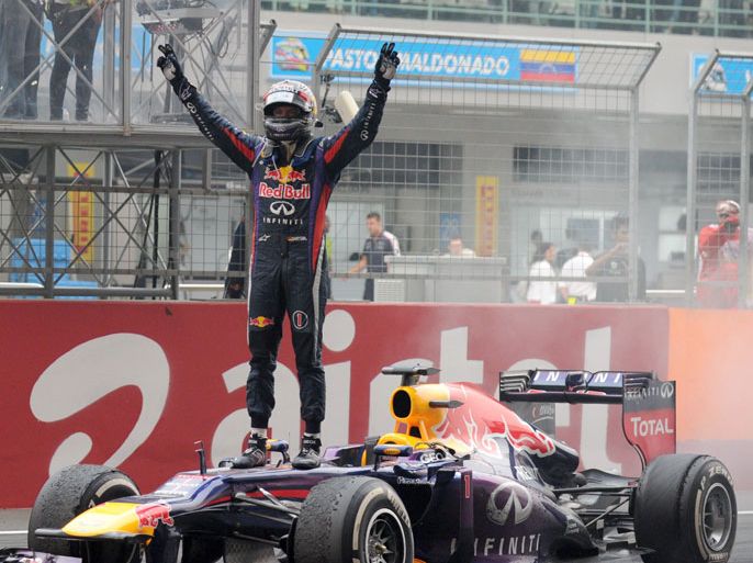 Red Bull driver Sebastian Vettel of Germany celebrates after winning the Formula One Indian Grand Prix 2013 at the Buddh International circuit in Greater Noida on the outskirts of New Delhi October 27,2013.AFP PHOTO/Prakash SINGH