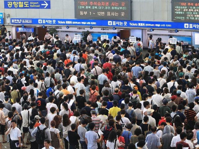 People wait in long queues to buy train tickets for their hometowns during the upcoming nation's biggest traditional holiday, Chusok, the Korean version of Thanksgiving Day, at Seoul Railway Station in Seoul, South Korea, Wednesday, Aug. 28, 2013. The government expects the number of hometown visitors and holidaymakers during the five-day, Sept. 18-22 holiday will exceed 35 million.