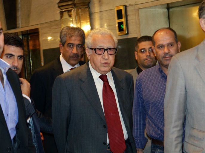 LOU991 - Damascus, -, SYRIA : UN-Arab League envoy to Syria Lakhdar Brahimi (C) leaves after a meeting with members of Syrian opposition on October 29, 2013 at the Sheraton hotel in Damascus. Brahimi visits Syria to seek support for peace talks, as violence prevented international inspectors from visiting two chemical weapons sites, in their first setback. AFP PHOTO LOUAI BESHARA