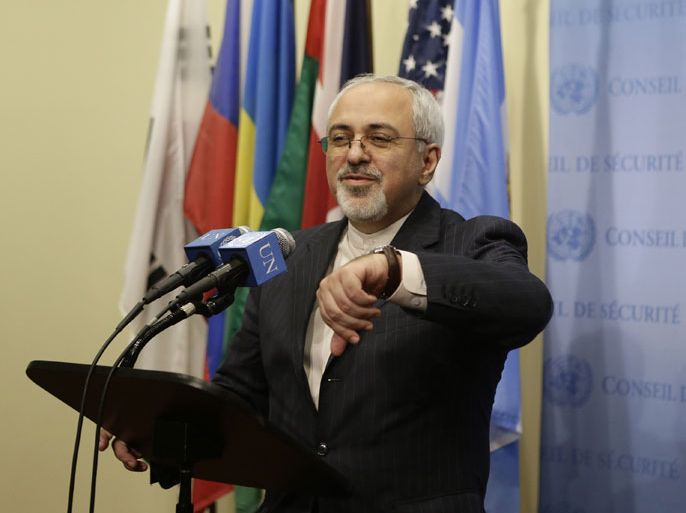 epa03885501 Foreign Minister of Iran Mohammad Javad Zarif checks his watch before he addresses the media after a meeting hosted by the European Union on the sidelines of the 68th Session of the United Nations General Assembly United Nations headquarters in New York City, New York, USA, 26 September 2013. The five permanent members of the United Nations security council plus Germany meet with Iran over their Nuclear Program. EPA/JASON SZENES