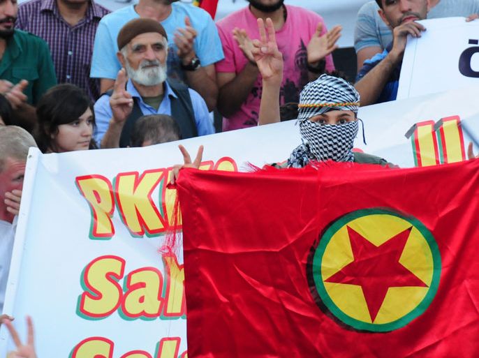 Kurdish child holds a flag of Kurdistan Workers Party`s (PKK) during a demonstration on September 30, 2013, in Diyarbakir. Prime Minister Recep Tayyip Erdogan announced reforms to enhance the rights of the country's Kurdish community, a key step in the peace process. AFP PHOTO / MEHMET ENGIN