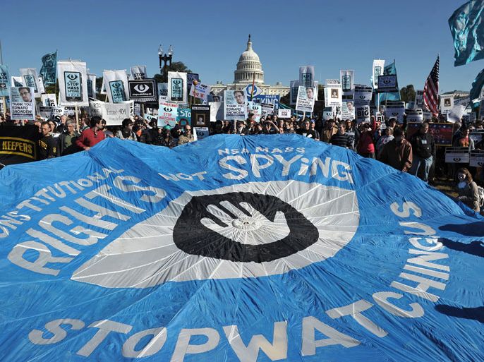 MNN020 - Washington, District of Columbia, UNITED STATES : A large banner calling for an end to government surveillance is seen during a protest on October 26, 2013 infront of the US Capitol in Washington, DC. The disclosures of widespread surveillance by the US National Security Agency of US allies has caused an international uproar, with leaders in Europe and Latin America demanding an accounting from the United States. AFP PHOTO/Mandel NGAN