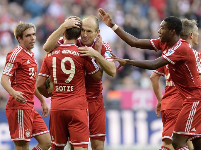 L-R) Bayern Munich's defender Philipp Lahm, Bayern Munich's midfielder Mario Goetze, Bayern Munich's Dutch midfielder Arjen Robben and Bayern Munich's Austrain midfielder David Alaba celebrate after the second goal for Munich during the German first division Bundesliga football match between FC Bayern Munich and FSV Mainz 05 on October 19, 2013 at the stadium in Munich, southern Germany. AFP PHOTO/CHRISTOF STACHE