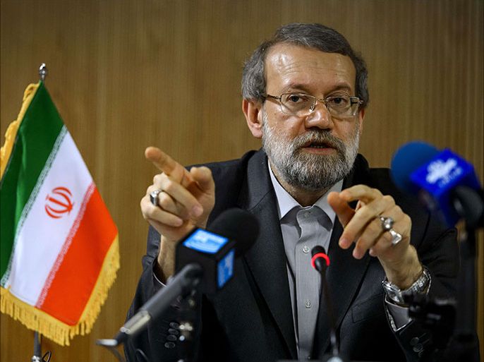 Iran's parliament speaker Ali Larijani gestures during a press conference on the sideline of the an International Parliamentary Union (IPU) assembly on October 9, 2013 in Geneva. World powers will meet again for talks with Iran on its suspect nuclear program on October 15 and 16 in Geneva. AFP PHOTO / FABRICE COFFRINI