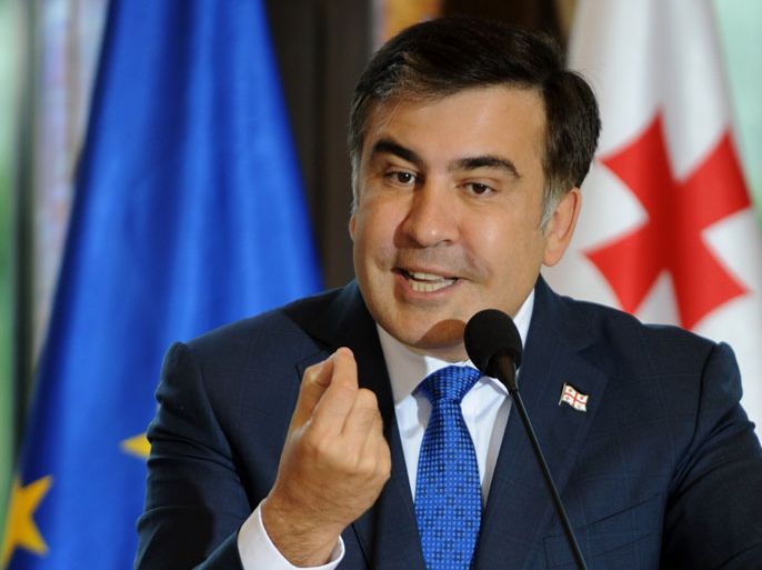 (FILES) A file photo taken on July 9, 2013 shows Georgian President Mikheil Saakashvili speaking at a a press conference after a meeting in Tbilisi with the EU commissioner for enlargement and european neighborhood policy. A revolutionary pro-Western moderniser to some and ham-fisted warmonger to others, flamboyant Saakashvili is set to leave office after transforming this tiny ex-ميخائيل ساكاشفيلي - جورجياSoviet state during a tumultuous decade in charge. Loved or loathed, few would argue that Saakashvili -- who must step down when his second term ends shortly after presidential polls on October 27 -- has left an indelible mark on the Caucasus nation of some 4.5 million. AFP PHOTO / VANO SHLAMOV