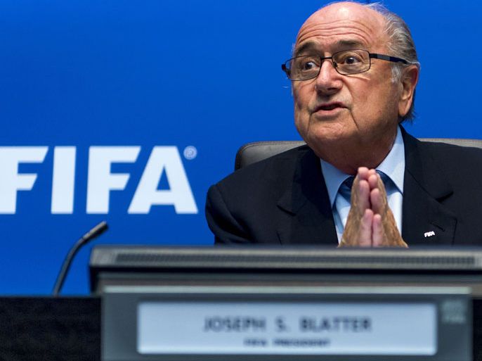 IFA President Sepp Blatter speaks during a press conference on October 4, 2013 at the FIFA headquarters in Zurich. FIFA said they could not get involved in labour issues in any country, amid calls for action after claims that dozens of migrant workers had died on construction projects linked to the 2022 World Cup in Qatar. Blatter, however said that the federation could not turn a blind eye to the reports, which also alleged that thousands of other workers endured conditions akin to "modern-day slavery" in Qatar. AFP PHOTO / FABRICE COFFRINI