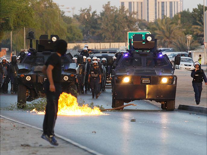A Molotov cocktail lands near riot police during a protest after the funeral of Yousif Ali Abdullah Al-Nashmi in the village of Sanabis, west of Manama, October 12, 2013. Al Wefaq, an Islamist group that says it advocates non-violent methods, said that Al Nashmi died due to denial of medical treatment while in jail. The Ministy of Interior said that he died of AIDS at Salmaniya Medical Complex. "The deceased was admitted to the hospital on September 23 in critical condition and was diagnosed with AIDS", North Governorate Persecutor Hassan Al Bouallay said. REUTERS/Hamad I Mohammed (BAHRAIN - Tags: POLITICS CIVIL UNREST)