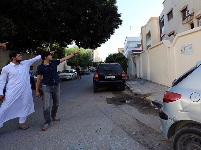 Abdullah al-Raghie (L) and Abdul Moheman al-Raghie (C), the sons of al-Qaeda suspect Abu Anas al-Libi point at the house next to the scene where their father was kidnapped by US special forces in a commando raid in Nofliene