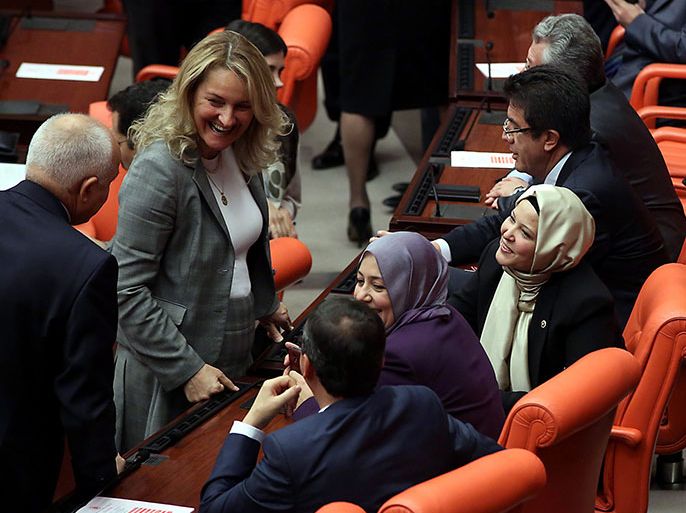 Turkey's ruling Justice and Development Party (AKP) MP's Nurcan Dalbudak (2nd R) and Sevde Beyazit Kacar (3rd R) discuss before a general assembly wearing headscarves at the Turkish Parliament in Ankara on October 31, 2013