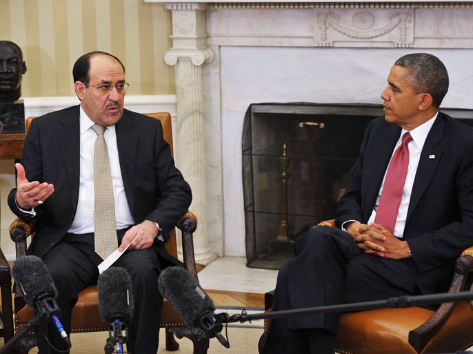 : Iraqi Prime Minister Nuri al-Maliki (L) speaks during a meeting with US President Barack Obama during a meeting in the Oval Office of the White House on November 1, 2013 in Washington. AFP PHOTO/Mandel NGAN