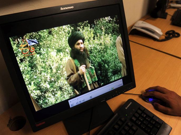 In this photograph taken on July 23, 2010, a Pakistani journalist watches a newly released video of radical Pakistani cleric Maulana Fazlullah in Peshawar. The Pakistani Taliban on November 7, 2013, have elected Maulana Fazlullah as their new chief following the death of the previous leader in a US drone strike. Fazlullah led the Taliban's brutal two-year rule in Pakistan's northwest valley of Swat in 2007-2009 before a military operation retook the area. AFP PHOTO