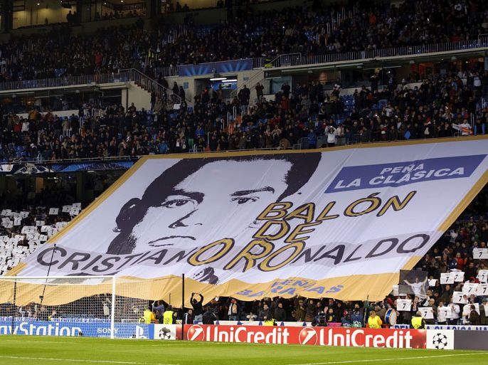 Real Madrid's supporters display a giant banner depicting Portuguese forward Cristiano Ronaldo to support his candidacy for the Golden Ball prior to the UEFA Champions League football match Real Madrid CF vs Galatasaray SK at the Santiago Bernabeu stadium in Madrid on November 27, 2013. AFP PHOTO/ DANI POZO